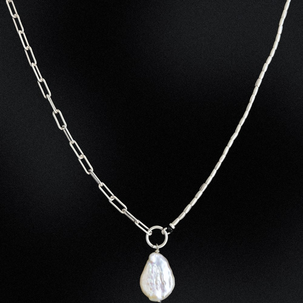 Pearl necklace with a silver chain on a black background