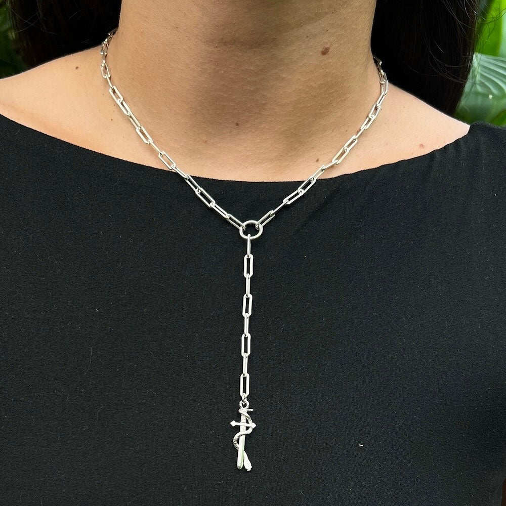Silver chain necklace with a pendant on a black shirt