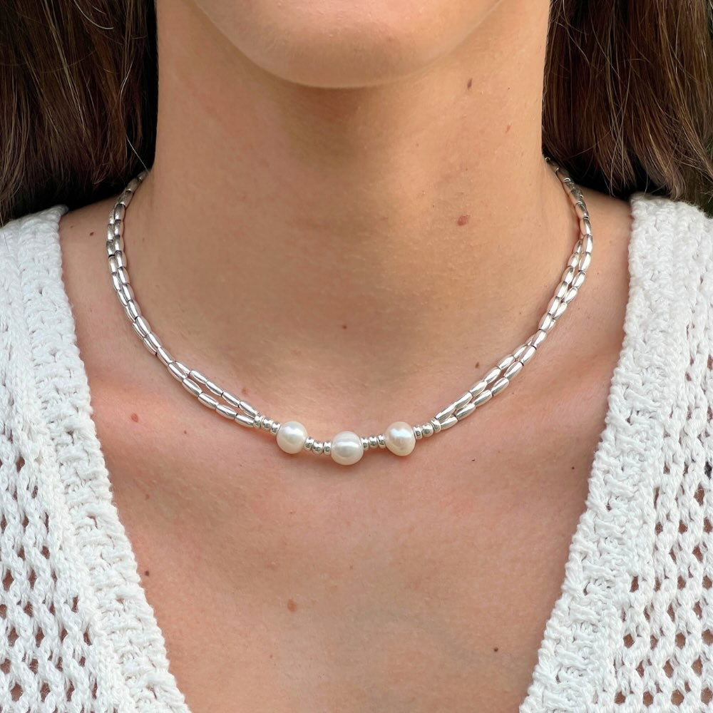 This Freshwater Pearls - Sterling Silver Beaded Necklace is a timeless classic. With a double stranded necklace and 3 big freshwater pearls at the centre, it exudes radiant elegance and style. Wear it for a special occasion or for a night out and dine in style.