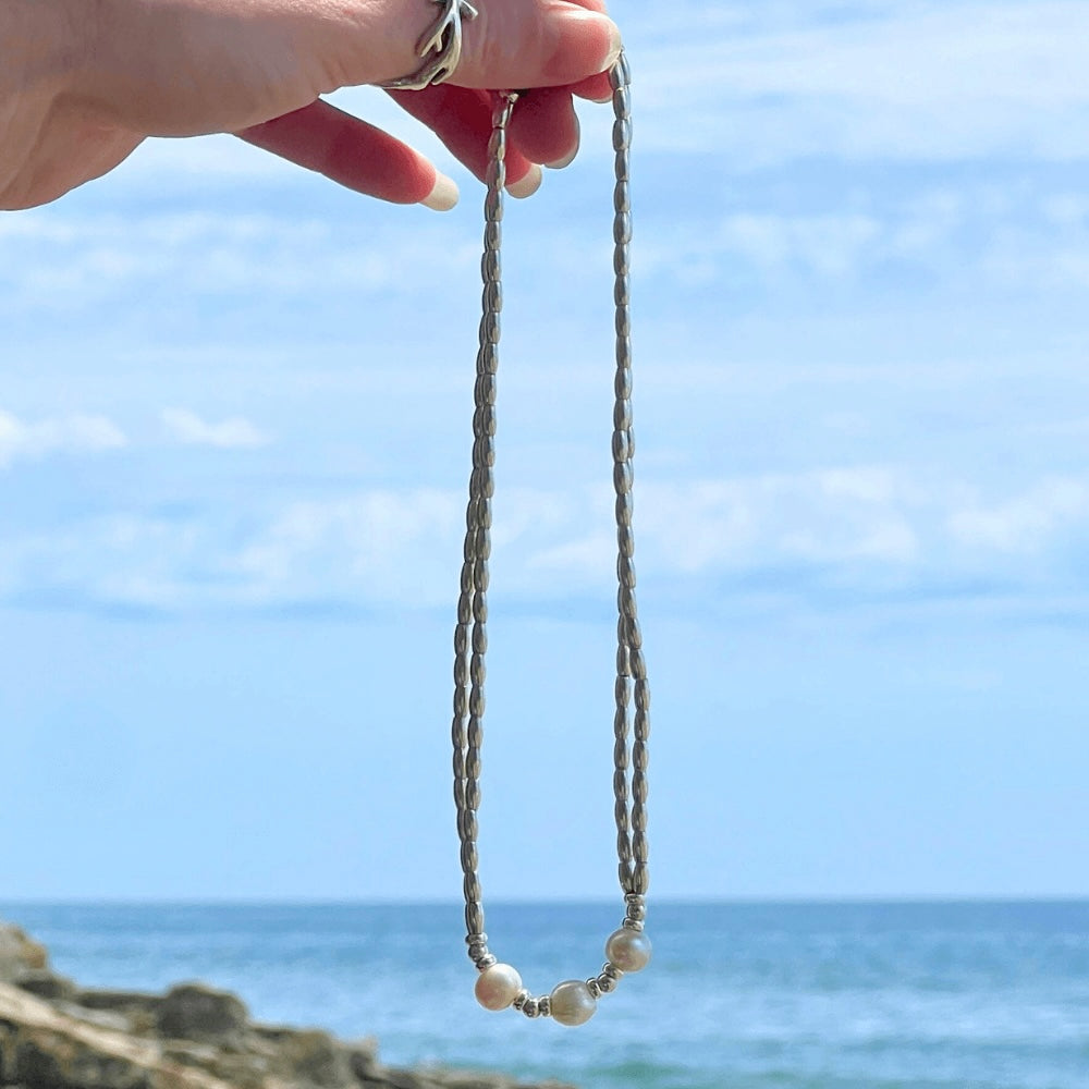 This Freshwater Pearls - Sterling Silver Beaded Necklace is a timeless classic. With a double stranded necklace and 3 big freshwater pearls at the centre, it exudes radiant elegance and style. Wear it for a special occasion or for a night out and dine in style.