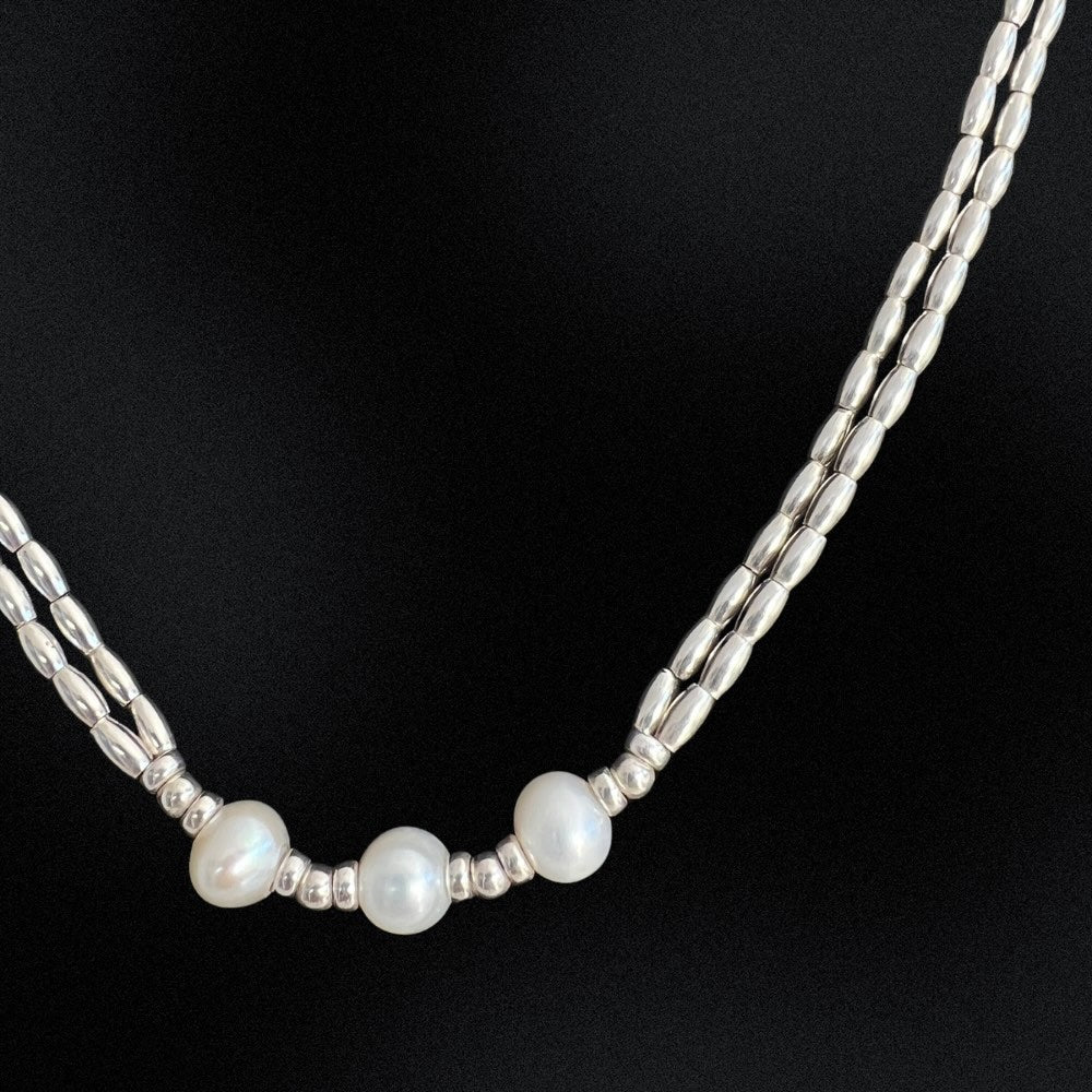 This Freshwater Pearls - Sterling Silver Beaded Necklace is a timeless classic. With a double stranded necklace and 3 big freshwater pearls at the centre, it exudes radiant elegance and style. Wear it for a special occasion or for a night out and dine in style.