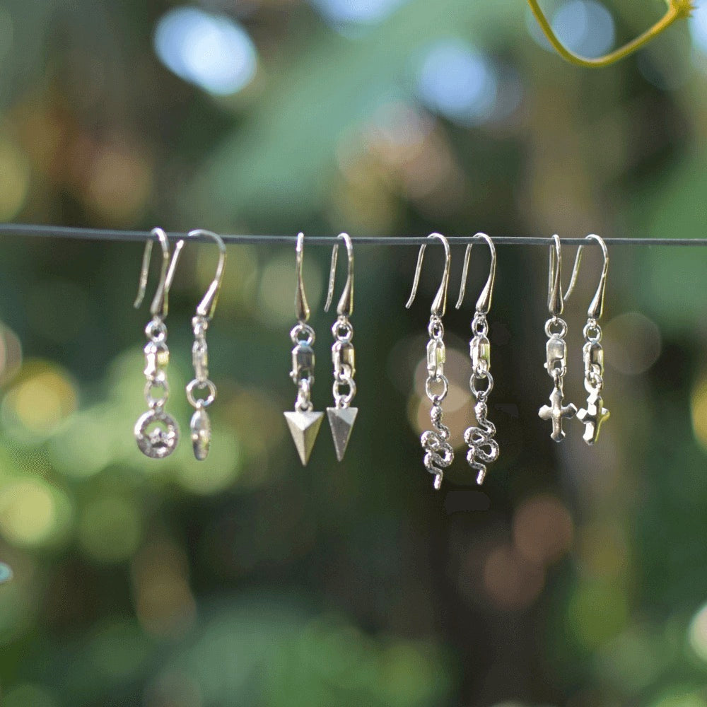 These earrings feature a modern and edgy design that is perfect for those who love to mix and match styles. But what makes these earrings truly special is that they are unisex. Anyone can rock these earrings and make them their own.  The earrings are hung from a lobster clasp and teardrop hook style, making them easy to wear and perfect for all-day wear. The triangular shape adds a touch of sophistication and uniqueness, making them perfect for both casual and formal occasions.