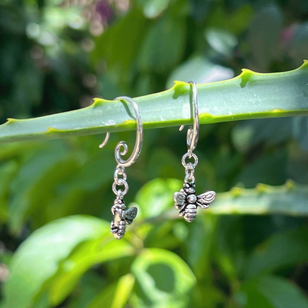 The earring hook boasts a unique and elegant swirl design, providing a modern and stylish touch to these timeless pieces. But what truly makes these earrings stand out is the delicate honey bee that dangles from the earring hook. The bee is meticulously crafted to ensure an accurate representation of this important and symbolic creature. These earrings are versatile enough to complete any outfit.