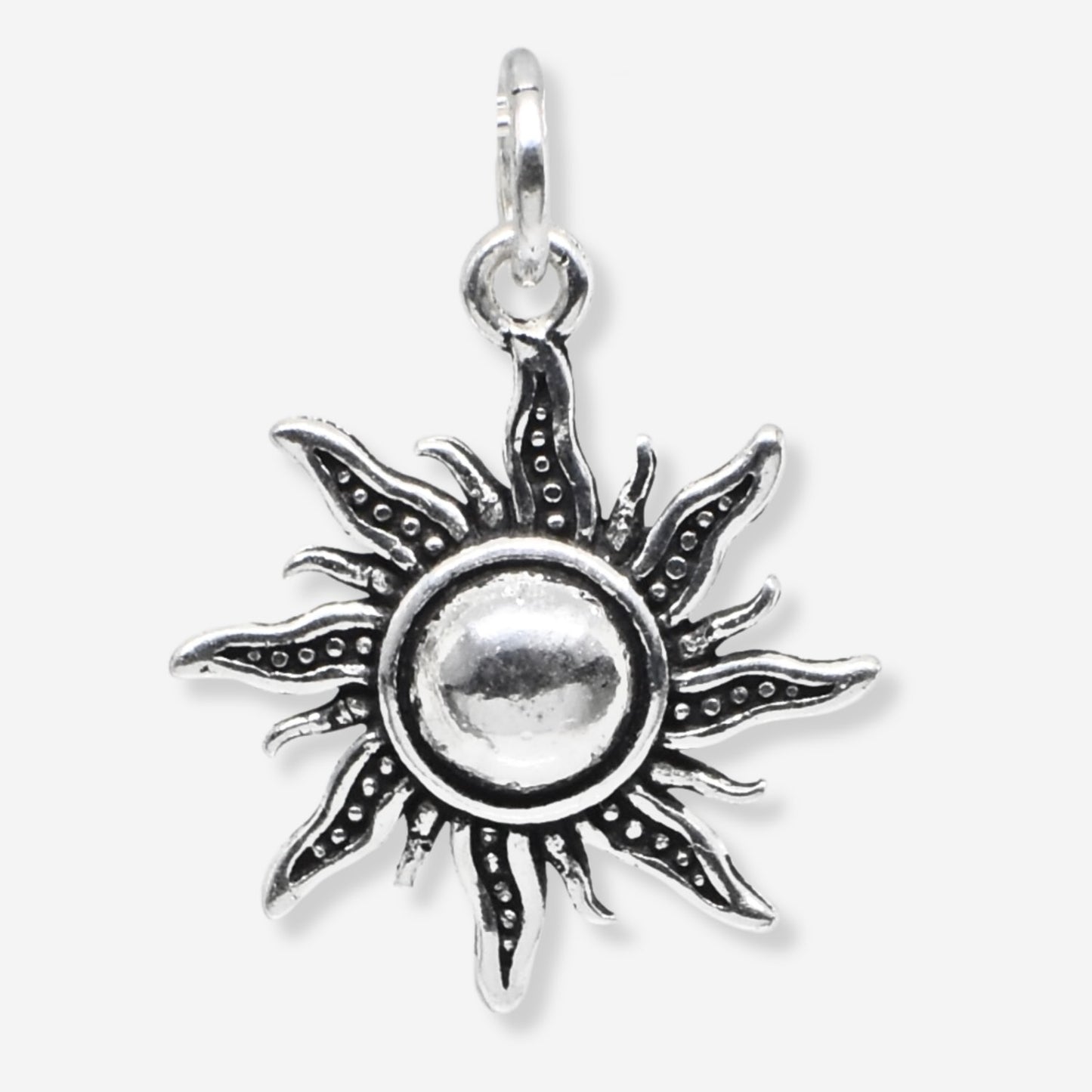Silver sun-shaped pendant on a white background