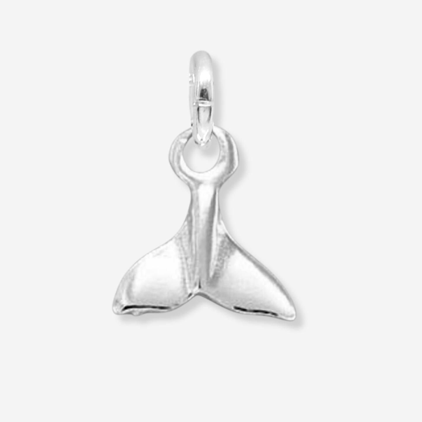 Silver whale tail pendant on a light gray background