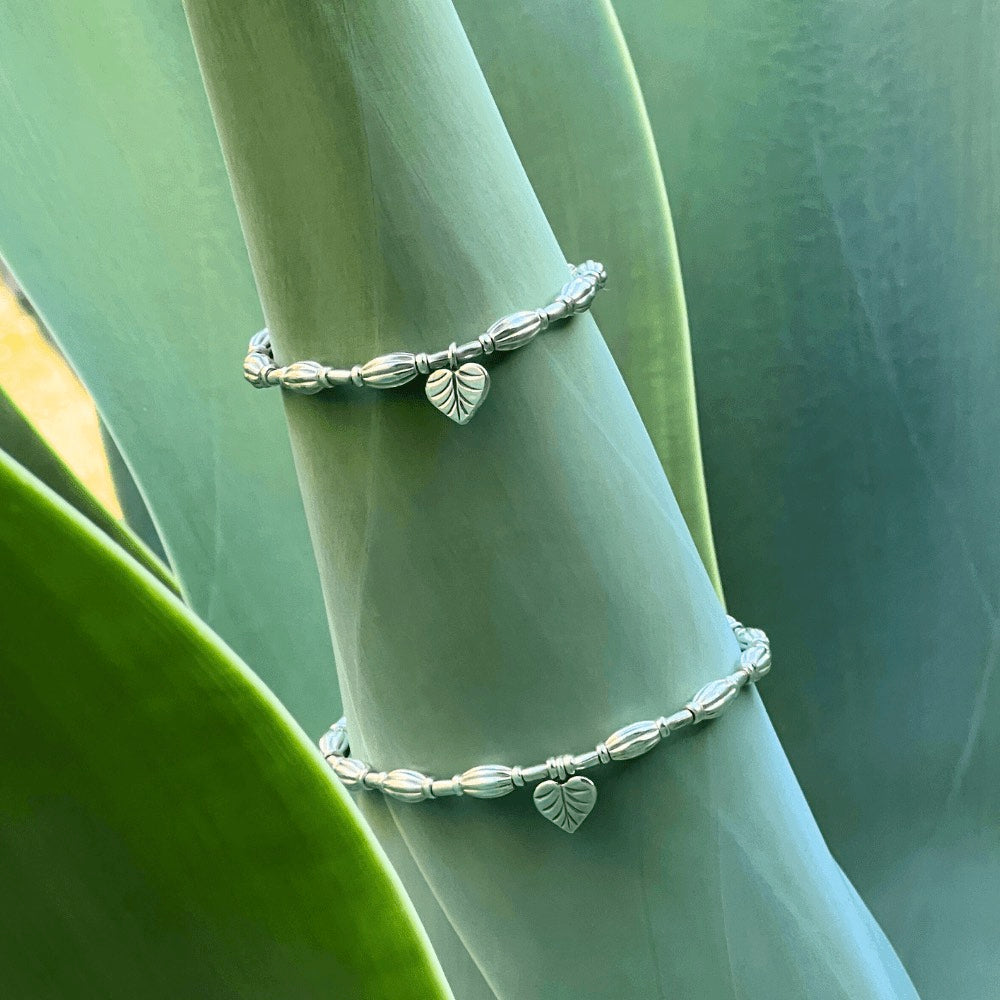 A true work of art. Handcrafted with intricate detail, this bracelet features a heart leaf charm at its centrepiece that is sure to capture your heart. The charm is complemented by corrugated beads that add a textural element to the bracelet.  Crafted from high-quality Hill Tribe Silver, the delicate balance of the charm and the beads brings together a perfect harmony of nature and artistry that is sure to make you stand out from the crowd.