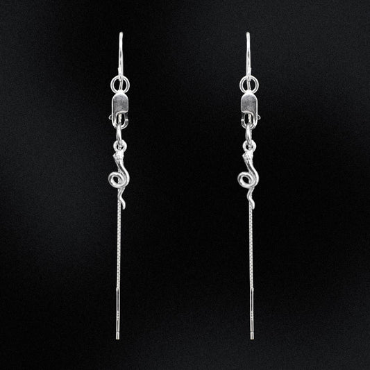 Pair of silver threader earrings on a black background
