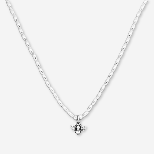 Silver necklace with a bee pendant on a white background
