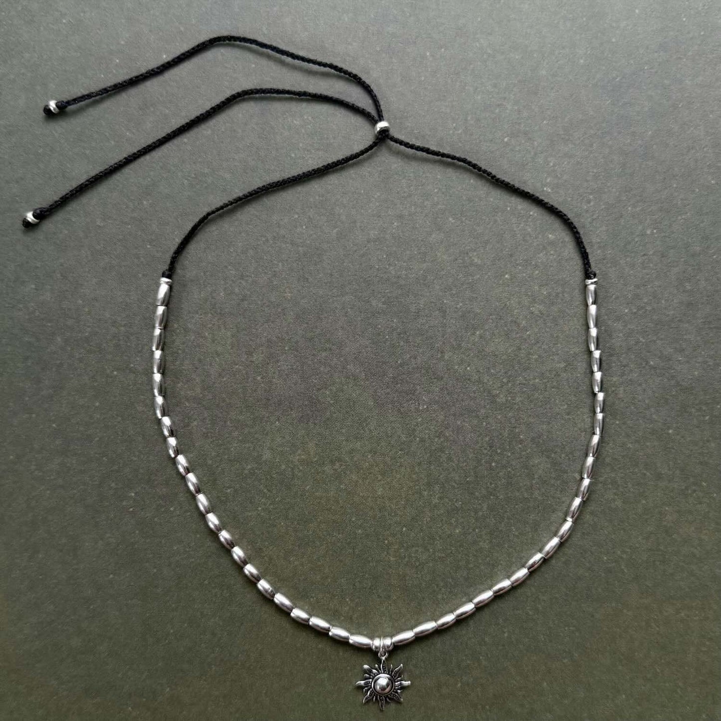 Necklace with a small pendant on a dark gray background