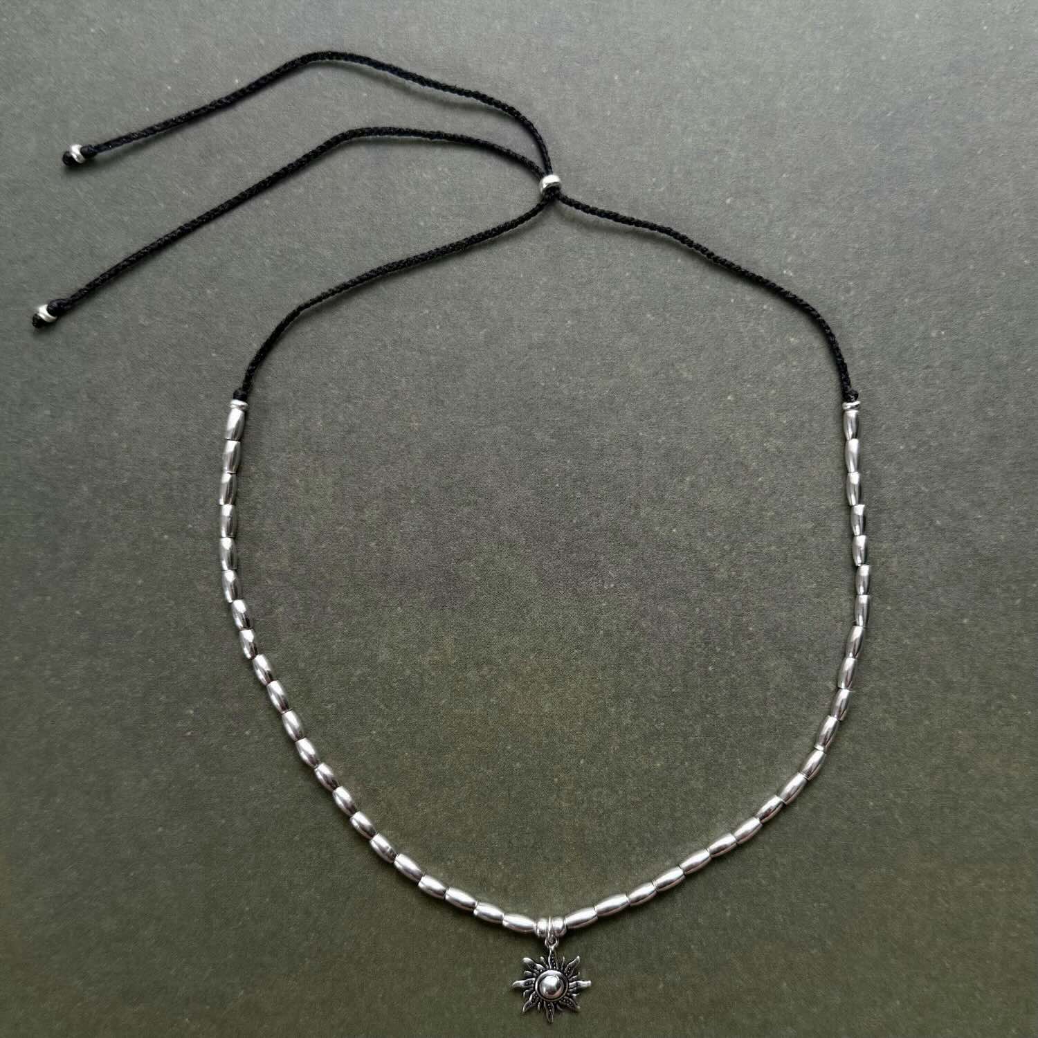 Necklace with a small pendant on a dark gray background