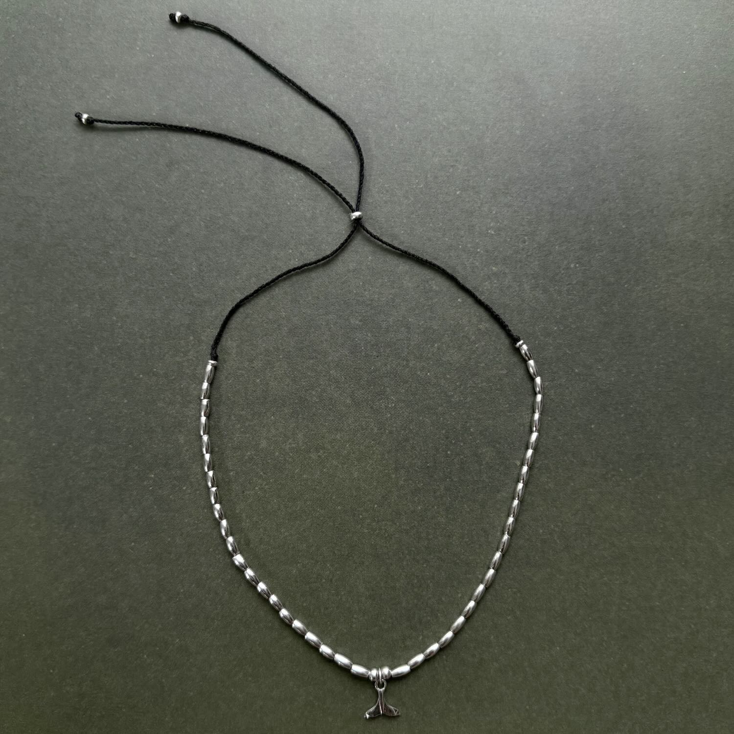 Necklace with a small pendant on a dark gray background
