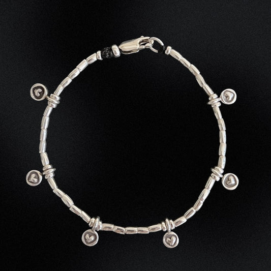 Indulge in love with our Endless Love Charm Silver Beaded Bracelet! Crafted with hill tribe silver beads on a wax string, this bracelet is adorned with six delicate heart charms, reminding you of love's infinite power. Perfect for any occasion, this bracelet will inspire you to spread love wherever you go!