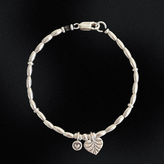 Join the Love Club with this adorable sterling silver beaded bracelet. Strung with delicate silver beads and two charming heart accents, this bracelet is sure to add a touch of love and style to any outfit. Whether you're feeling flirty or romantic, this bracelet has got you covered!