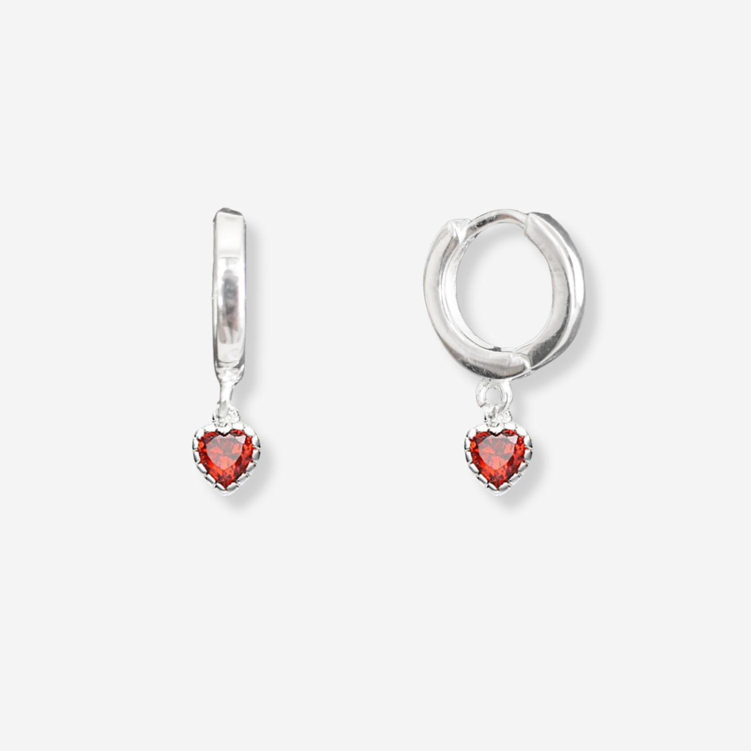 Silver hoop earrings with red heart-shaped stones on a white background