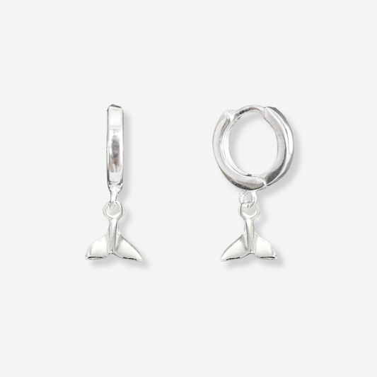 Silver mermaid tail earrings on a white background