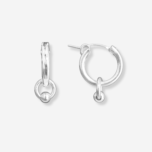 Pair of silver hoop earrings on a light gray background