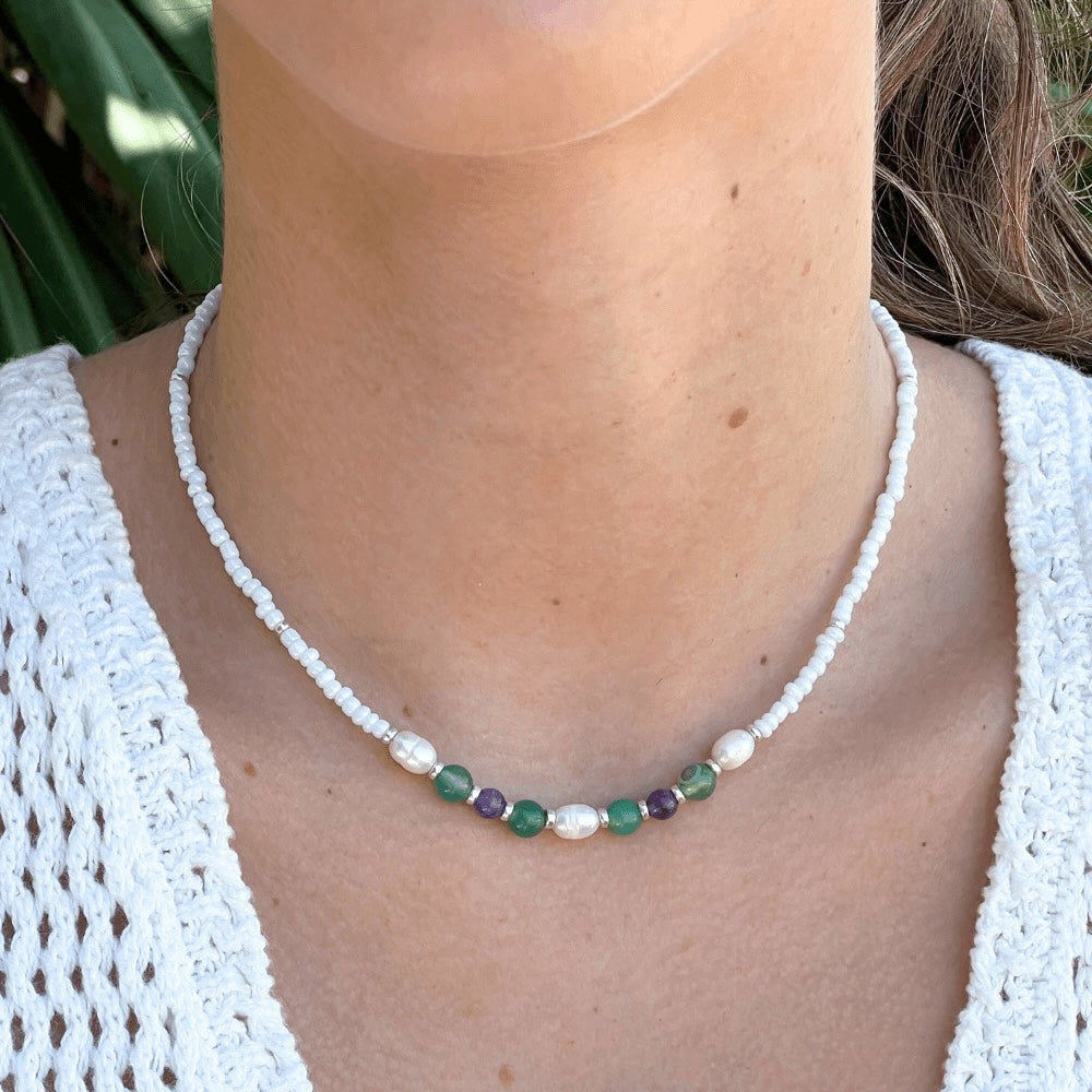 Unleash your inner wild child with this gorgeous Venice White, Green & Purple Beaded Choker. Handmade in Australia with seed beads and freshwater pearls, this summer piece will make you stand out from the crowd. Show off your style and grab attention.