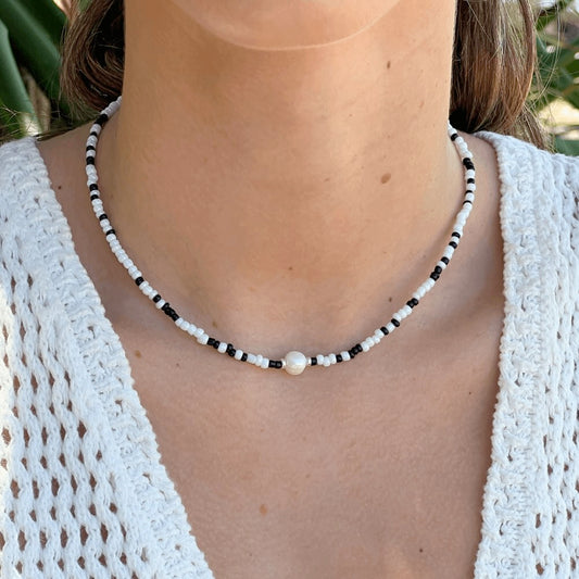 This stunning Black & White Beaded Choker Necklace will captivate your audience. Handcrafted in Australia with a freshwater pearl in the centre, this beautiful piece will instantly elevate any outfit, adding a unique touch of sophistication and flair.