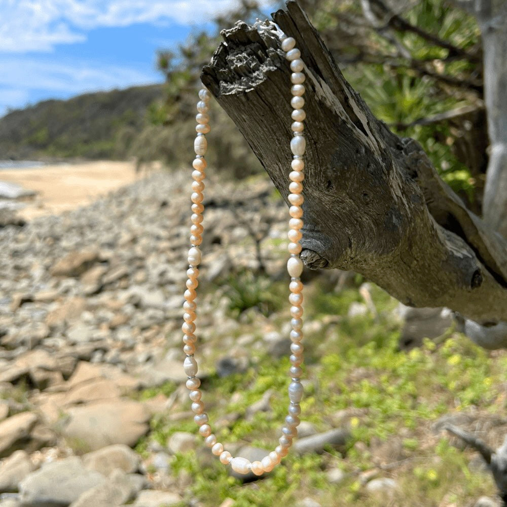 Be summer-ready with this handmade Apricot Freshwater Pearl Beaded Choker Necklace, crafted in Australia. Make a lasting impression with this stunning piece, perfect for any occasion and sure to turn heads. A must-have addition to your jewellery collection!