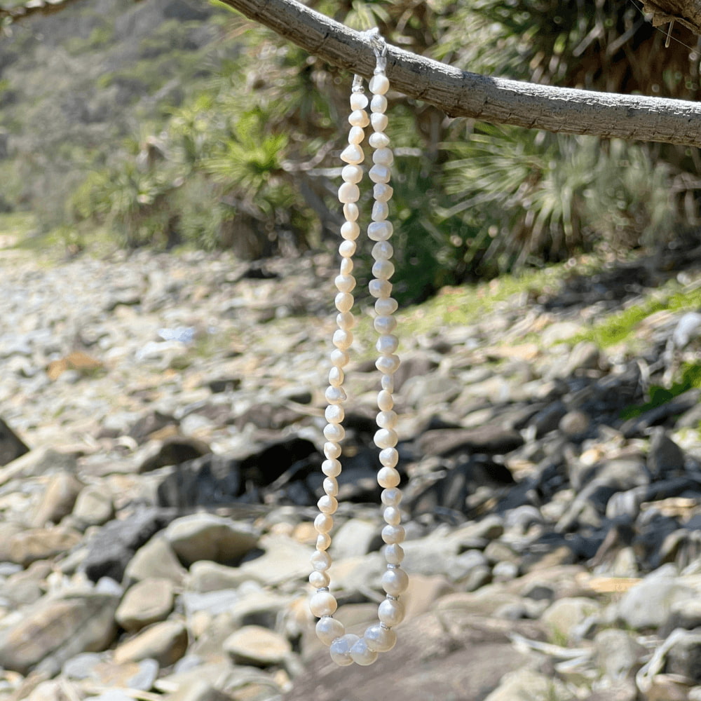 Add a touch of elegance to your summer wardrobe with this Freshwater Pearl Beaded Choker Necklace. Handmade in Australia with pearls and sterling silver beads, this stunning necklace is sure to turn heads. Add a touch of class to any look with this timeless classic.
