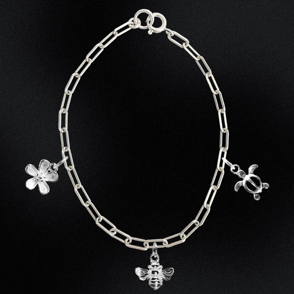 Silver chain bracelet with charms on a black background