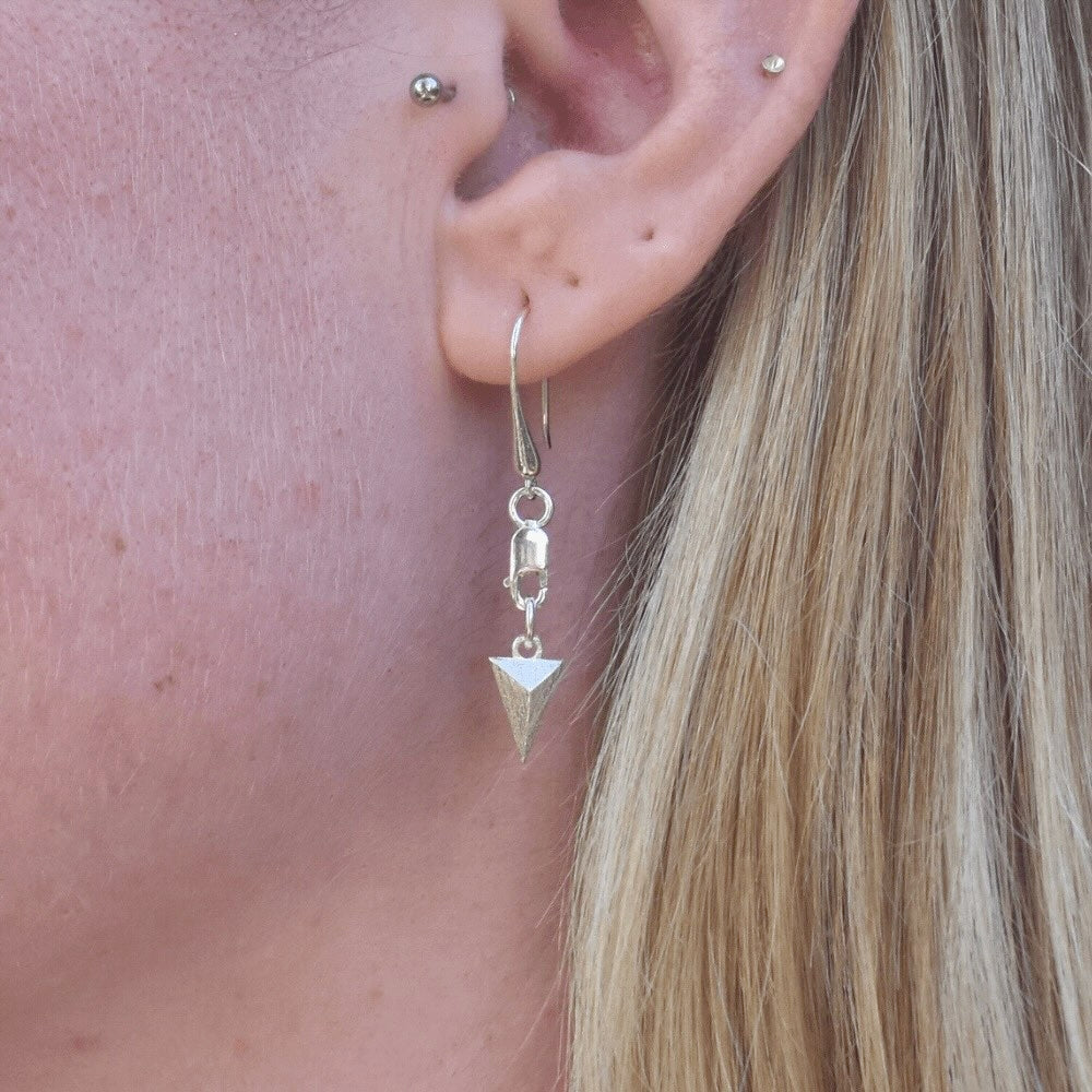 These earrings feature a modern and edgy design that is perfect for those who love to mix and match styles. But what makes these earrings truly special is that they are unisex. Anyone can rock these earrings and make them their own. ﻿ The earrings are hung from a lobster clasp and teardrop hook style, making them easy to wear and perfect for all-day wear. The triangular shape adds a touch of sophistication and uniqueness, making them perfect for both casual and formal occasions.