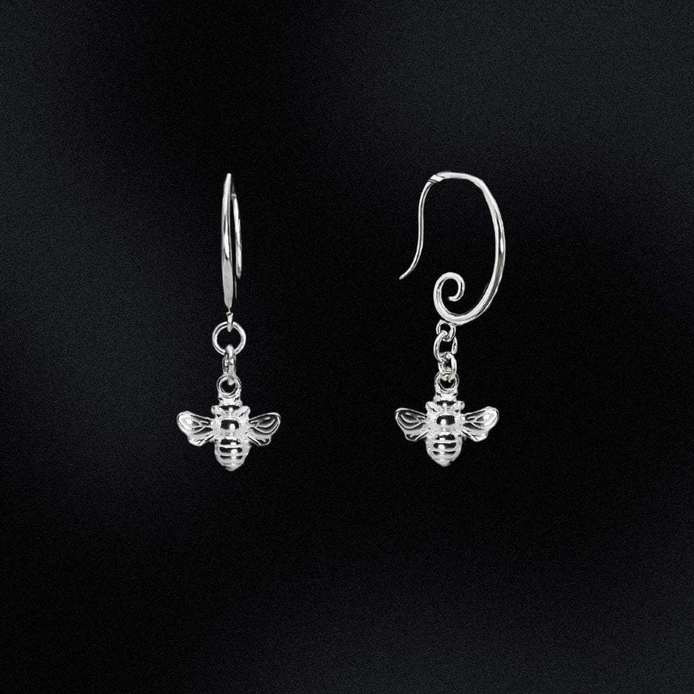 Silver bee earrings on a black background