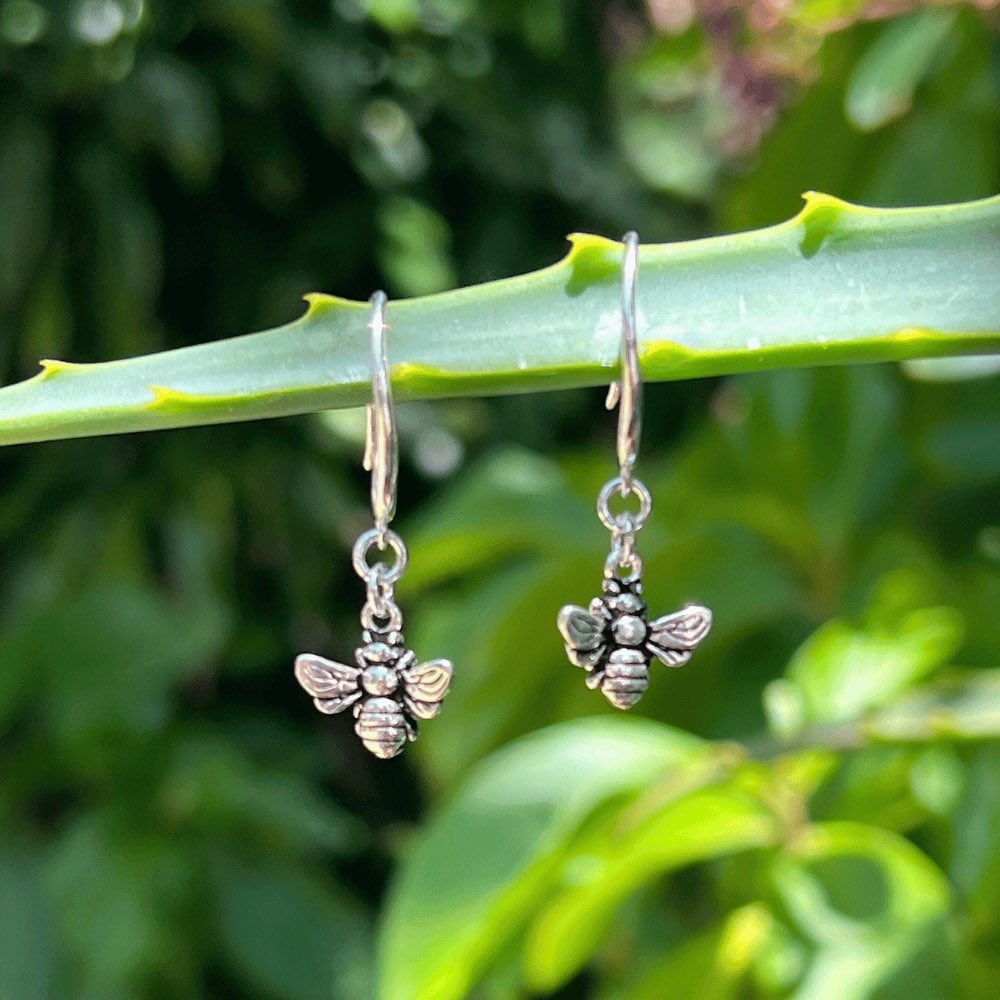 The earring hook boasts a unique and elegant swirl design, providing a modern and stylish touch to these timeless pieces. But what truly makes these earrings stand out is the delicate honey bee that dangles from the earring hook. The bee is meticulously crafted to ensure an accurate representation of this important and symbolic creature.  These earrings are versatile enough to complete any outfit. 