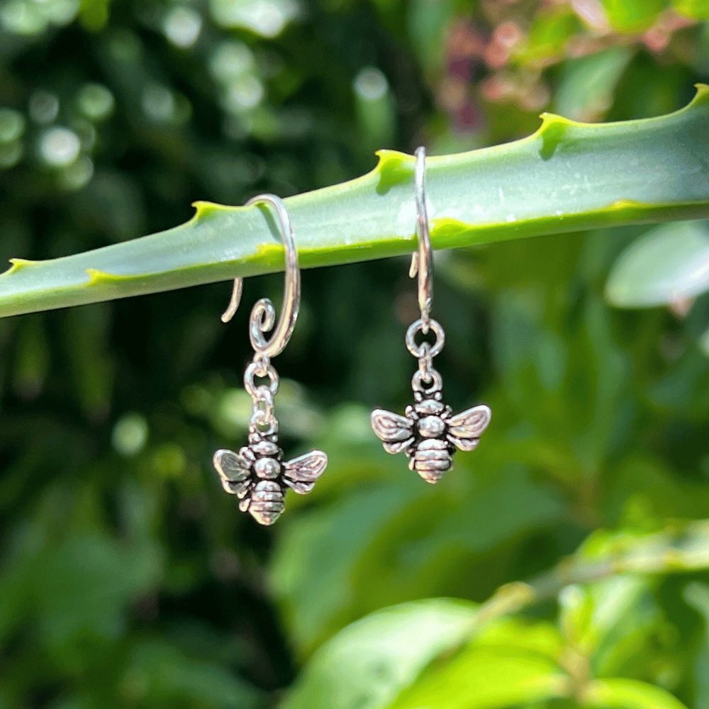 The earring hook boasts a unique and elegant swirl design, providing a modern and stylish touch to these timeless pieces. But what truly makes these earrings stand out is the delicate honey bee that dangles from the earring hook. The bee is meticulously crafted to ensure an accurate representation of this important and symbolic creature.  These earrings are versatile enough to complete any outfit. 