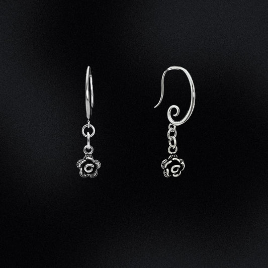 Featuring a gorgeous swirl earring hook that delicately and securely attaches to your ear, these earrings are perfect for any occasion. But what truly makes them unique is the intricately designed Black and Silver rose flower charm that dangles from the bottom of each earring.