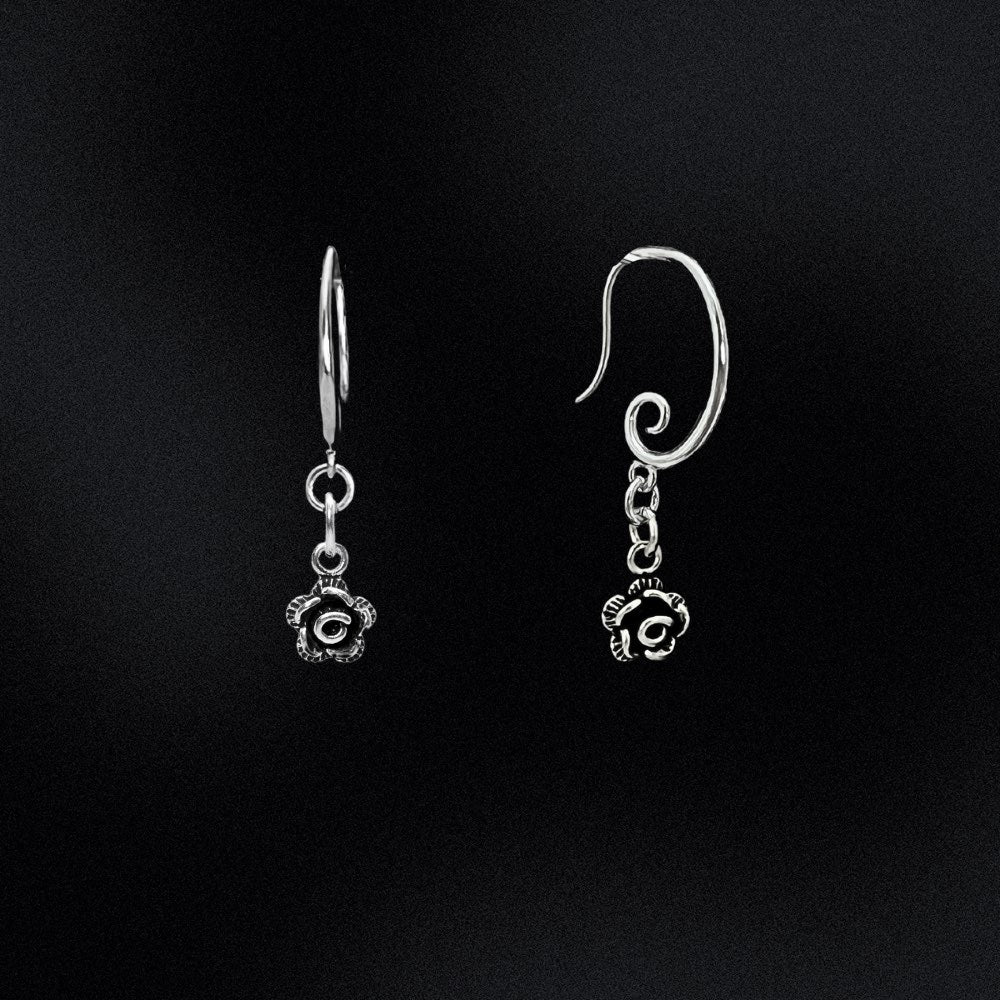 Featuring a gorgeous swirl earring hook that delicately and securely attaches to your ear, these earrings are perfect for any occasion. But what truly makes them unique is the intricately designed Black and Silver rose flower charm that dangles from the bottom of each earring.