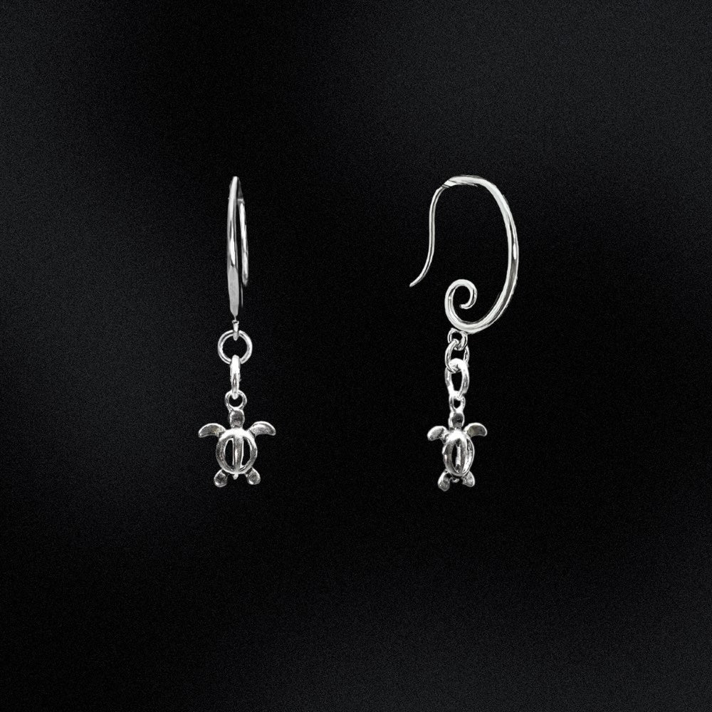 Indulge in the allure of the sea and make a statement with these exquisite earrings.  Crafted from high-quality sterling silver, these earrings feature a captivating swirl design and a charming Sea Turtle charm. Add a touch of oceanic allure to your everyday look with these versatile and stylish earrings. Embrace the spirit of the sea effortlessly!
