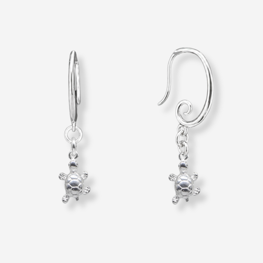 Pair of silver turtle earrings on a white background