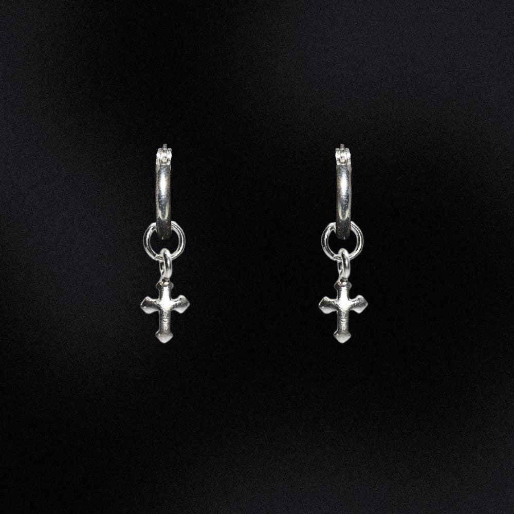 Made from premium-quality sterling silver, these earrings boast a sleek and timeless design that's perfect for everyday wear. The holy hoop design creates a seamless look, making it seem as though the hoops are floating effortlessly. At the bottom of each hoop dangle a pair of intricately crafted cross charms. These tiny symbols of faith will remind you of your spirituality, keeping you connected to your beliefs no matter where you go.