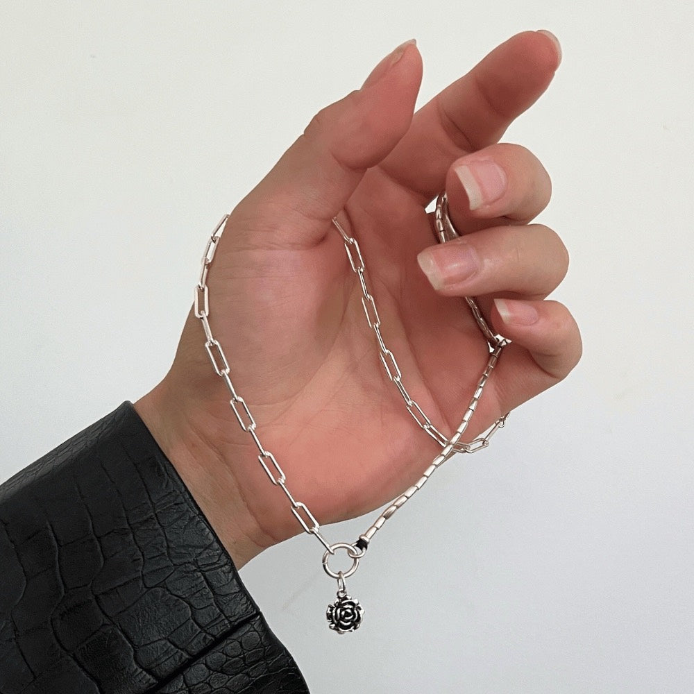 A stunning piece of jewellery that combines the best of both worlds. Made from 925 sterling silver, this necklace features a unique design that incorporates a half paperclip chain and half Hill tribe silver beads.  The result is a beautifully balanced piece that is both elegant and modern. The necklace also features a beautiful rose charm made of sterling silver that sits perfectly in the centre of the piece.