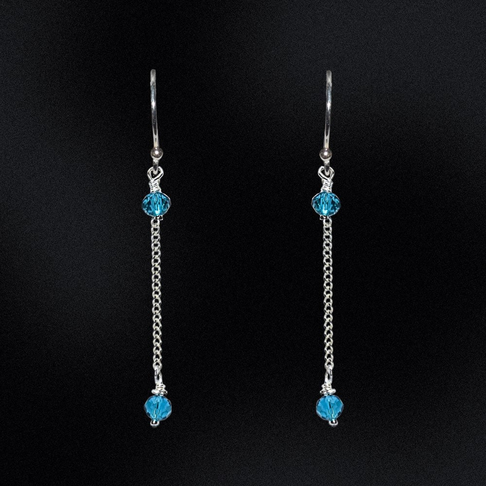 These earrings are a stunning addition to any wardrobe, perfect for adding a touch of elegance to any outfit. The earrings are made from high-quality sterling silver, ensuring their durability and long-lasting beauty. The earrings feature faceted glass rondelle beads in azure blue that are hung from a curb chain. The black beads are absolutely striking against the sterling silver and the chain adds a unique and modern twist to these timeless earrings.