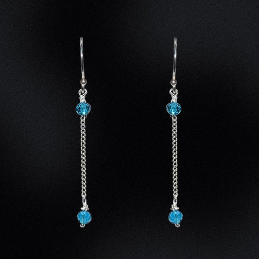 These earrings are a stunning addition to any wardrobe, perfect for adding a touch of elegance to any outfit. The earrings are made from high-quality sterling silver, ensuring their durability and long-lasting beauty. The earrings feature faceted glass rondelle beads in azure blue that are hung from a curb chain. The black beads are absolutely striking against the sterling silver and the chain adds a unique and modern twist to these timeless earrings.