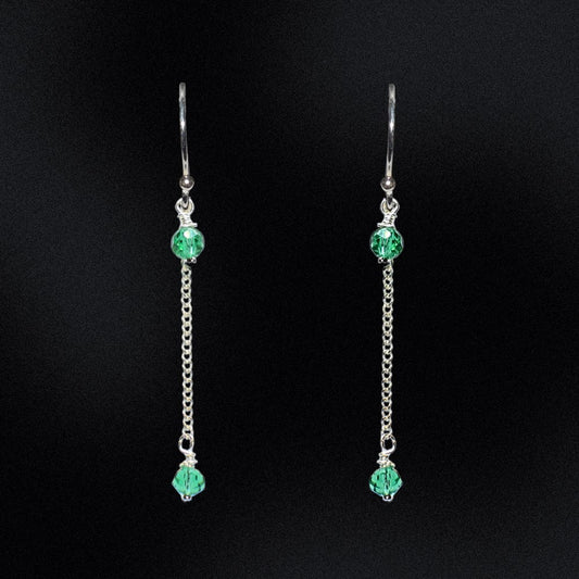 These earrings are a stunning addition to any wardrobe, perfect for adding a touch of elegance to any outfit. The earrings are made from high-quality sterling silver, ensuring their durability and long-lasting beauty. The earrings feature faceted glass rondelle beads in emerald green that are hung from a curb chain. The black beads are absolutely striking against the sterling silver and the chain adds a unique and modern twist to these timeless earrings.
