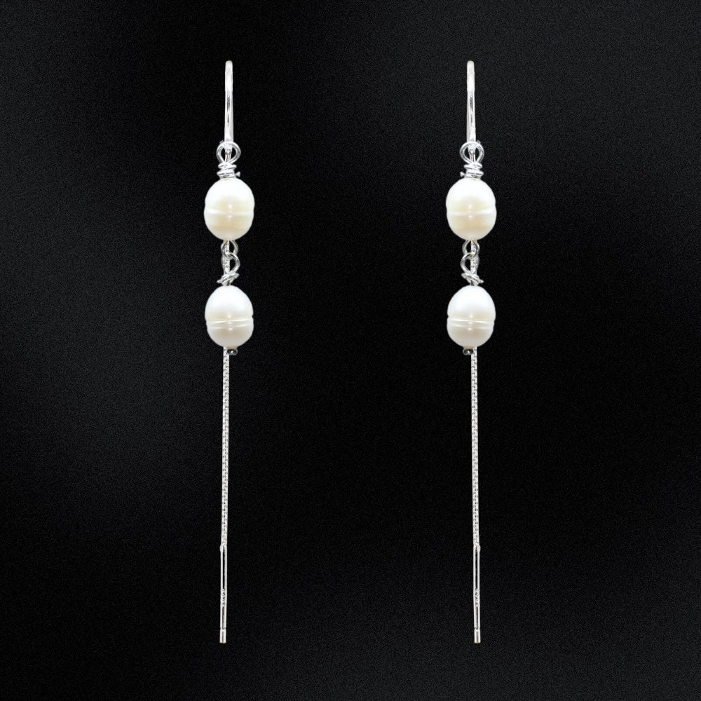 Add some drama and edge to your everyday look with these freshwater double pearl threader earrings! Handcrafted with two freshwater pearls and sterling silver, these earrings will make any outfit double-take fabulous. Perfect for any occasion, add a little pearl-fection to your wardrobe!