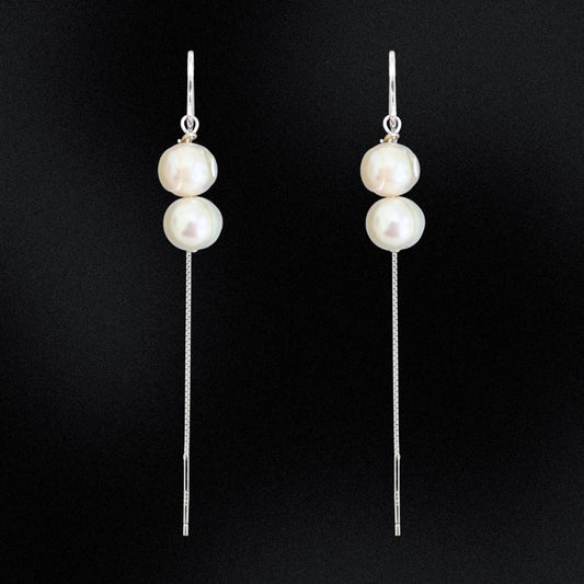 These Double Pearl Stack Threader Earrings are a stunning addition to any jewellery collection! Handcrafted in Australia with sterling silver, these earrings are perfect for any occasion. Exquisite, sophisticated, and stylish, these earrings will add a luxurious sparkle to any ensemble!