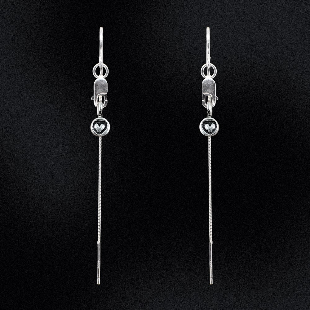 These earrings are a true embodiment of love, featuring delicate tiny heart charms that will dangle gracefully from your earlobes. The heart charms are carefully crafted with pure sterling silver, giving the earrings a shiny, high-quality finish that is both stunning and timeless. The threader style of the earrings is unique and easy to wear. The earrings are designed with a lobster clasp, which allows for easy and secure attachment.