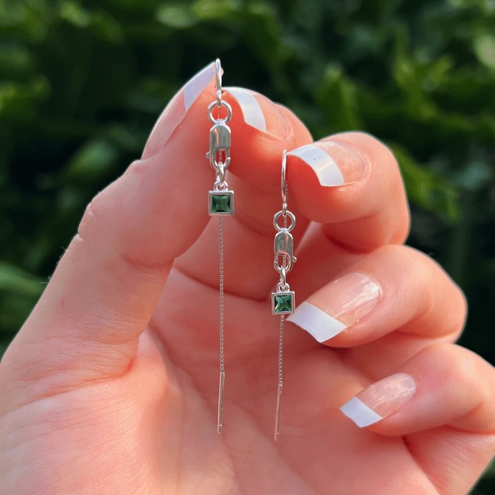 Introducing our Evergreen Thread Earrings! These gorgeous earrings feature delicate threads that dangle from a sleek and secure lobster clasp, adding a touch of elegance to any outfit. The earrings are adorned with a beautiful green square charm, adding a pop of colour that is sure to turn heads.