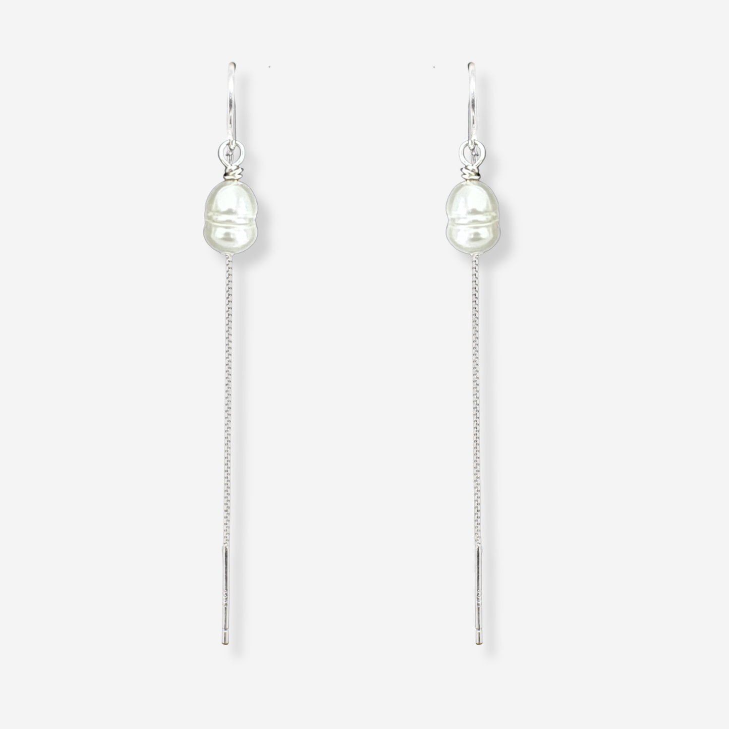 Pair of pearl drop earrings on a white background