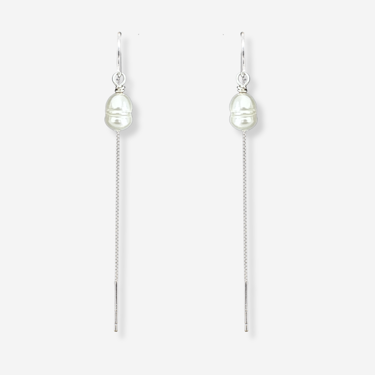 Pair of pearl drop earrings on a white background