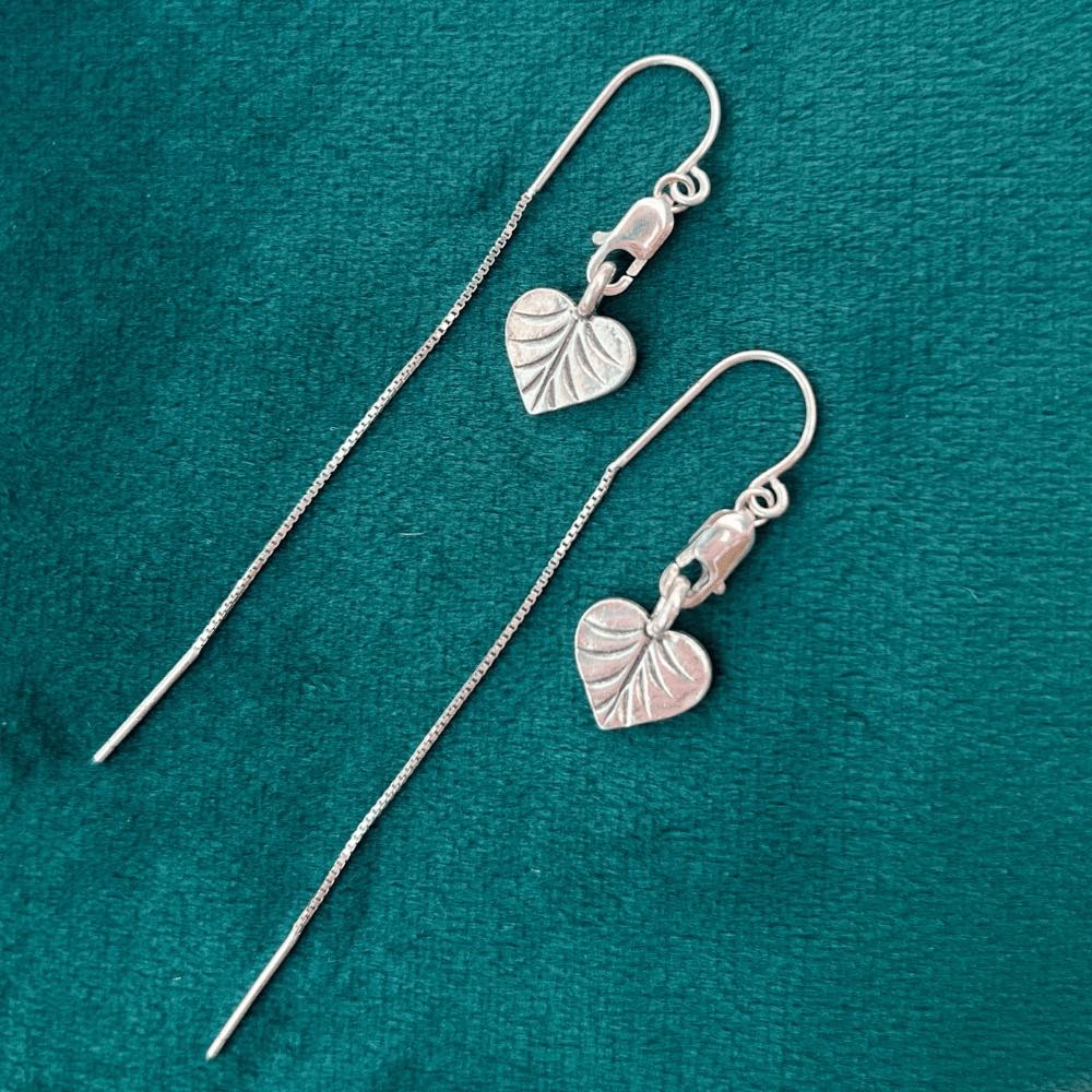 Love nature? Get ready to fall head-over-heels for our Heart-Shaped Leaf Threaders! Crafted from genuine sterling silver, these eye-catching earrings will add a subtle touch of romance to any look.   They're lightweight and airy, so you can show off your boho-style without weighing yourself down. Plus, they make a great gift for the nature-loving fashionista in your life.