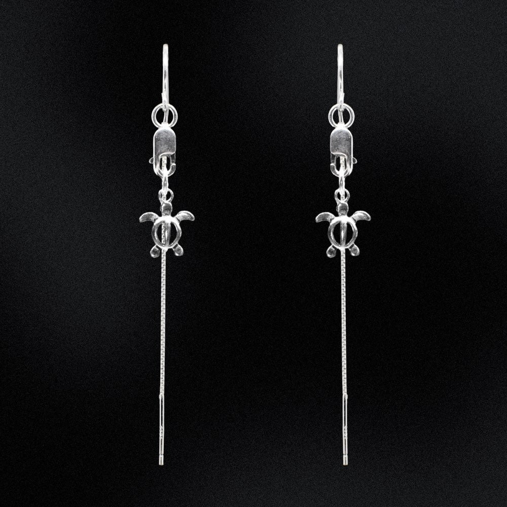 Take a whimsical dive into the ocean with these handmade Sterling Silver Turtle Threader Earrings from Australia. Inspired by the sea, these earrings will add a touch of playfulness to any outfit. Swim in style with these unique threader earrings!