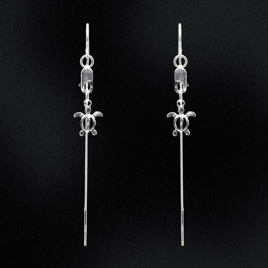 Take a whimsical dive into the ocean with these handmade Sterling Silver Turtle Threader Earrings from Australia. Inspired by the sea, these earrings will add a touch of playfulness to any outfit. Swim in style with these unique threader earrings!