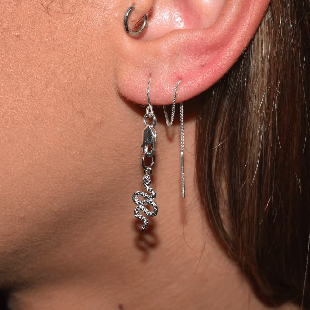 Slither in style and make a statement with these bold and daring sterling silver thread Earrings. The sleek and sophisticated snake charm adds a tasteful touch to any outfit, while the threader style keeps 'em comfy and secure all day. Dare to be different and show off your wild side; make an effortless transition from work to play with one easy accessory.