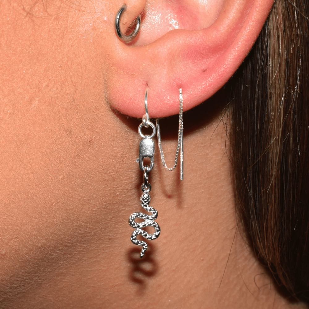 Slither in style and make a statement with these bold and daring sterling silver thread Earrings. The sleek and sophisticated snake charm adds a tasteful touch to any outfit, while the threader style keeps 'em comfy and secure all day. Dare to be different and show off your wild side; make an effortless transition from work to play with one easy accessory.
