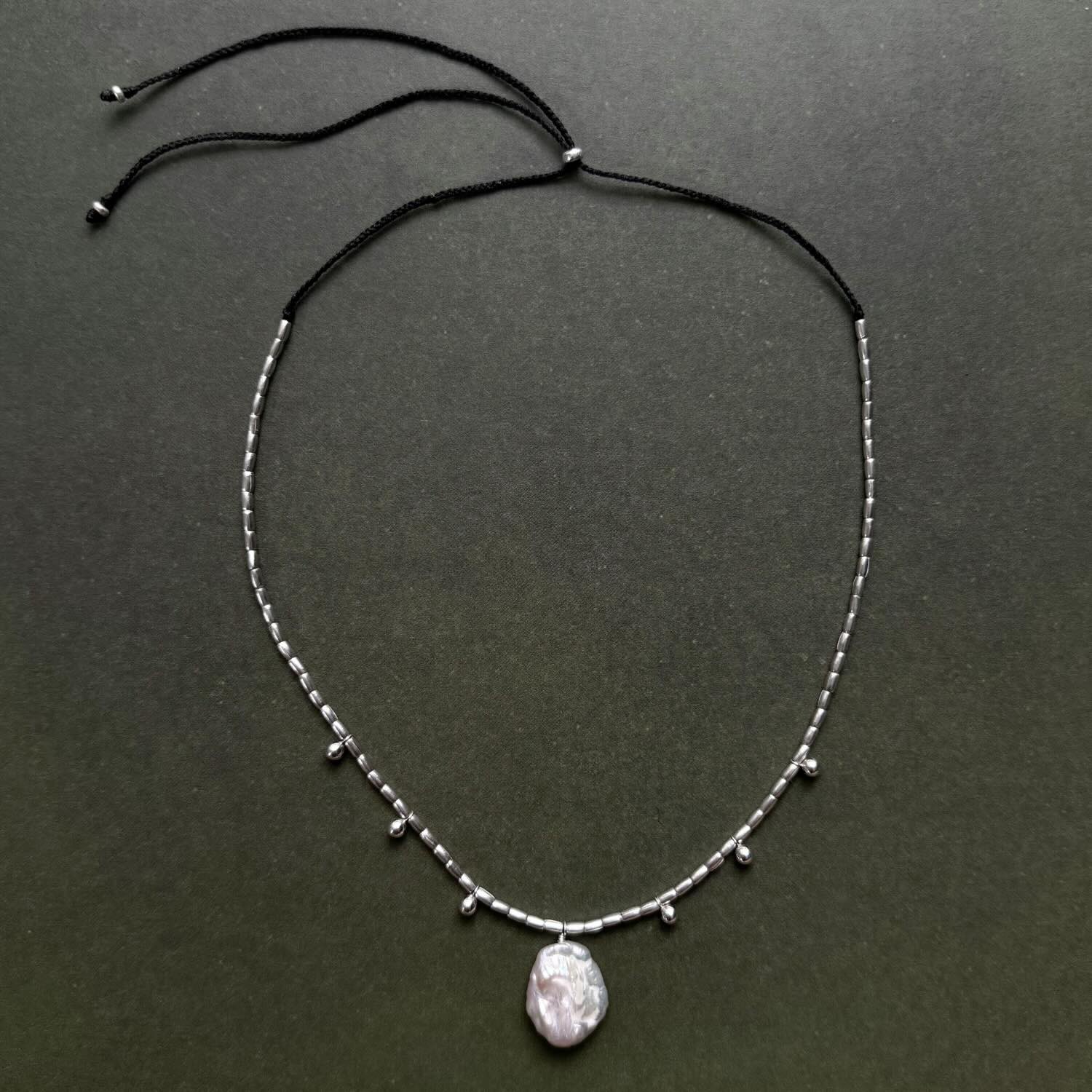 Necklace with a pendant on a dark gray background